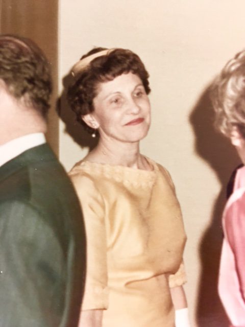 Wearing her signature yellow, Grandma chatting with guests at my parents' wedding